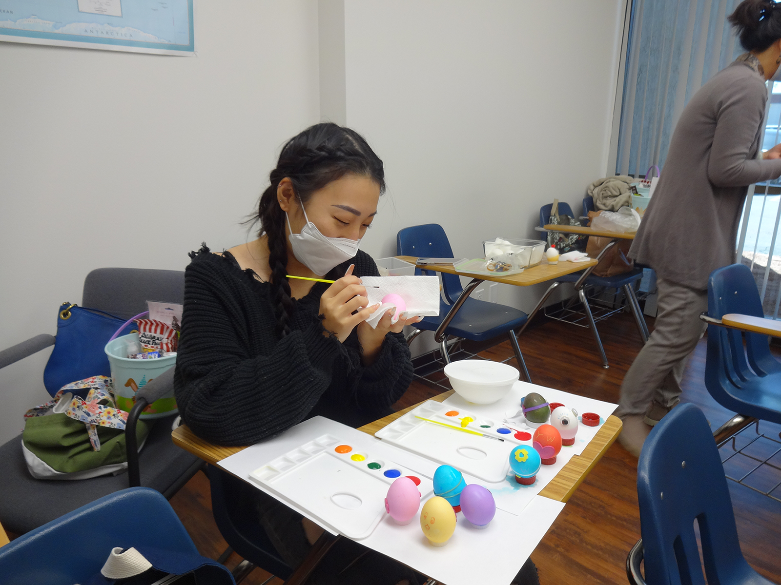 Student painting an easter egg