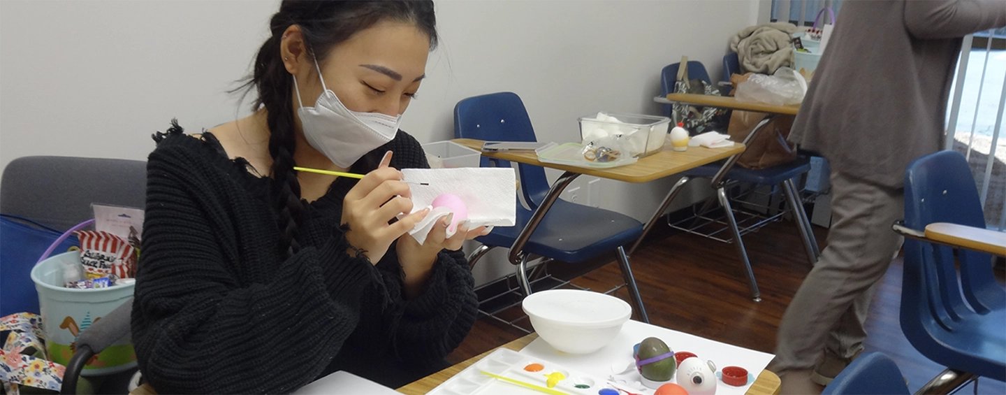 Student coloring an easter egg for the american culture class