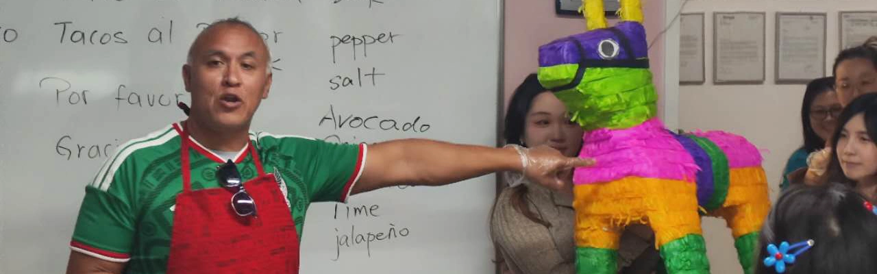Students and teachers celebrating in with a piñata