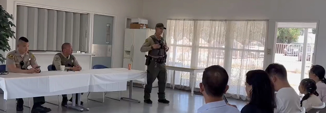 Police officer giving a presentation to students