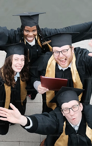 Three student in graduation robes 